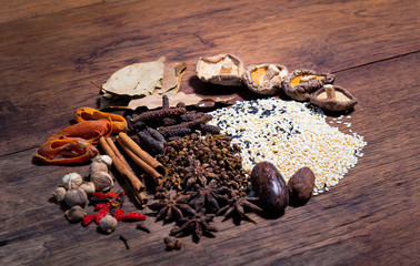 Spices and herbs on old kitchen table. Food and cuisine ingredients.