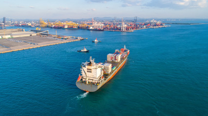 container ship in import export and business logistic.By crane ,Trade Port , Shipping.cargo to harbor.Aerial view.Water transport.International.Shell Marine.Top view.