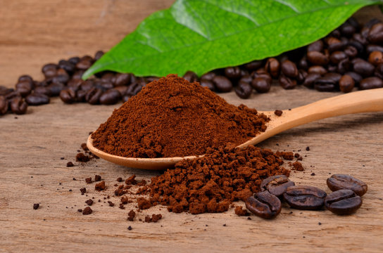  coffee beans and ground coffee on a wooden background