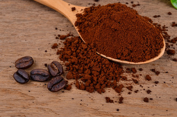  coffee beans and ground coffee on a wooden background