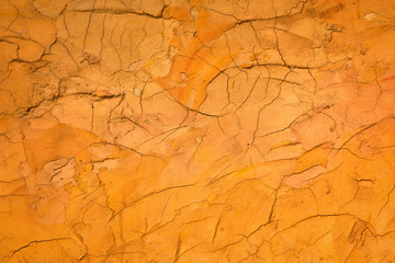Orange rough cement wall background and texture