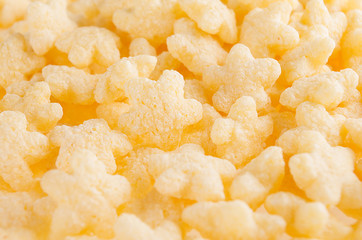 Yellow stars corn flakes closeup, cereals texture.