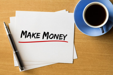 Make money - handwriting on papers with cup of coffee and pen, business concept