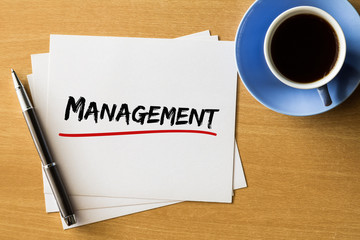 Management - handwriting on papers with cup of coffee and pen, business concept