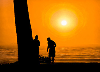 Illustration, digital painting of surfers silhouette against the ocean at sunrise in Durban South Africa