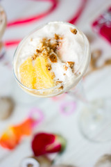 Ice cream dessert on table with hearts, ribbons and cloves.