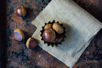 Chestnuts over rustic background
