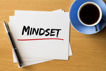 Mindset - handwriting on papers with cup of coffee and pen, business concept