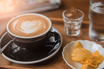 Cup coffee and set food and drink on wooden table in coffee shop at morning  .