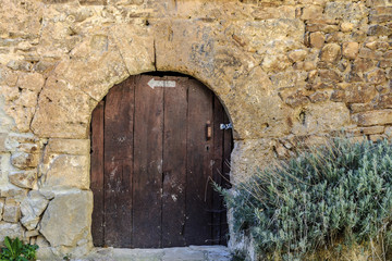Fototapeta na wymiar medieval door in the town of Orbaneja of the Castle in the province of Burgos in Castile and Leon, Spain
