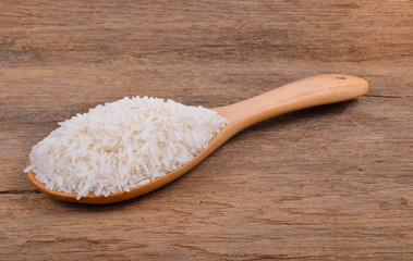 Rice with wooden spoon on wooden