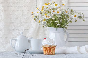 Fresh Oxeye Daisies on table in white Pitcher in interior