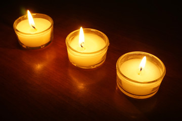 Candle light flame on dark background.