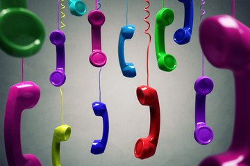 Red and multi-coloured telephone receiver hanging