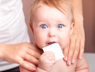 Baby in doctors office receiving osteopathic treatment of shoulders