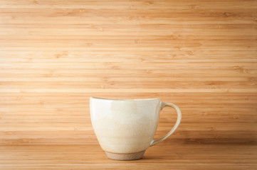 Coffee mug on wooden table.