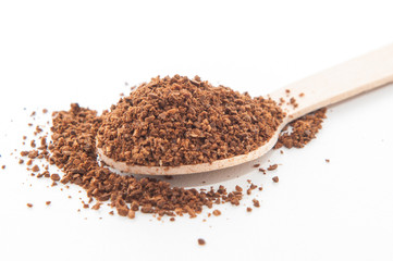Coffee powder in wooden spoon.
