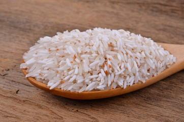 Rice on a wooden spoon on a wooden