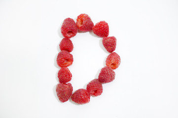 Alphabetical letter D made of raspberries on a white background