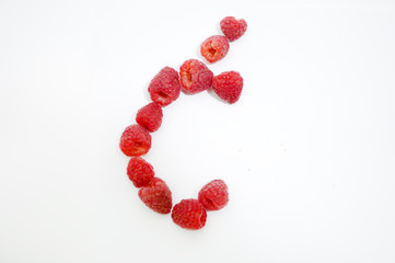 Alphabetical letter Ć made of raspberries on a white background