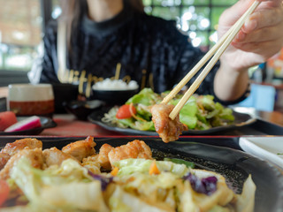Asian woman enjoy eating Japanese food in the resturant