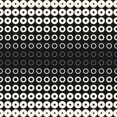 Fototapeta na wymiar Halftone circles vector seamless pattern. Abstract geometric texture with different sized rings. Stylish monochrome background, gradient transition effect. Modern design for prints, digital, web