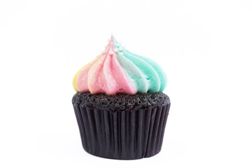 Unicorn cupcake. Pastel cream on top of chocolate cupcake isolated on a white background. Rainbow frosted cupcakes looks like an angel