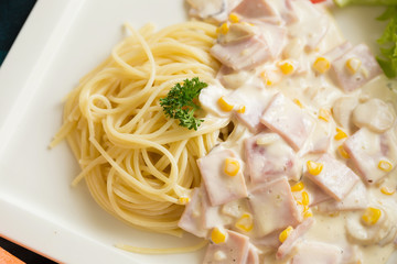Delicious pasta carbonara with bacon and parmesan in a white plate. homemade food style