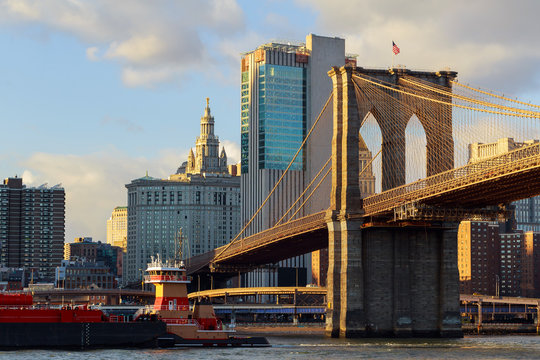 The Brooklyn Bridge stands against blue sky downtown Manhattan skyscrapers