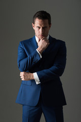 Thoughtful man with serious face and stylish hair in suit