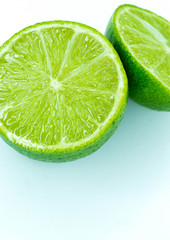 Sliced ripe juicy lime close-up on white