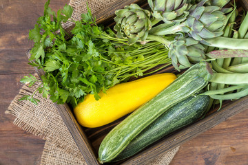 Fresh organic green vegetables wooden floor with copy space. Green and yellow vegetables background. Healthy eating background. Vegetarian food, organic food.