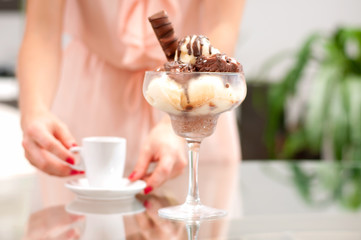 Happy woman eating chocolate and vanilla  ice cream.
