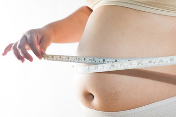 big belly of a fat man and measuring tape isolated on white