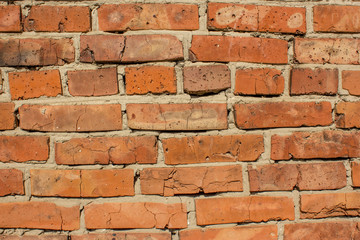 Texture of an old red brick wall close up