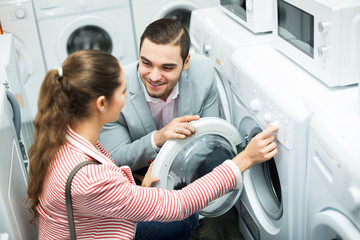 Young couple choosing washing machine