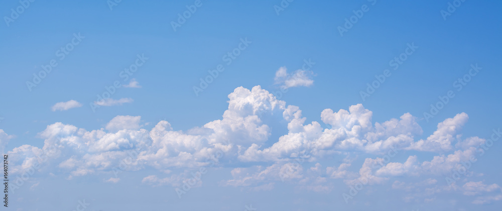 Wall mural white curly clouds in a blue sky. sky background