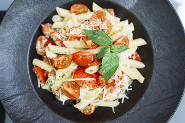 Penne pasta with cheese and cherry tomato