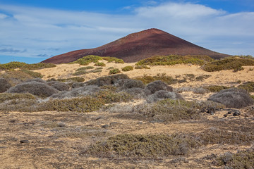 Picturesque red volcano illuminated by sunlight on Graciosa island, Lanzarote, Canary Islands, Spain