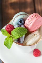 Assorted colofrul macarons with fresh berries
