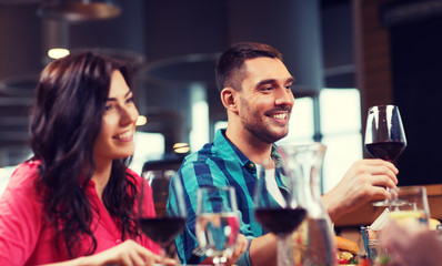 friends clinking glasses of wine at restaurant
