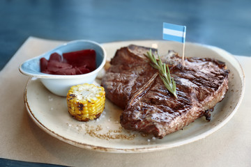 Composition with tasty beefsteak and vegetables on plate