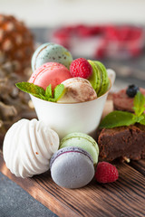 Assorted colofrul macarons with fresh berries