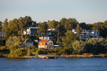 View on luxury cottages along Stockholm archipelago, Sweden. Summer sunset time.