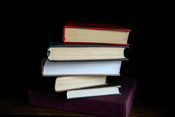Paper books stacked shelf in the interior. Education and intelligence are well-read people. Old gadgets from short stories and novels. The passing of time read.