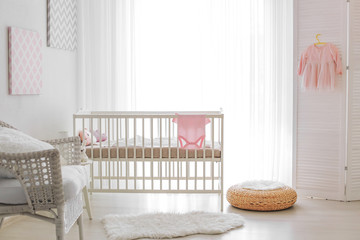 Modern interior design of baby room with crib