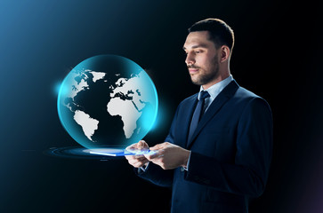 businessman with tablet pc and earth projection