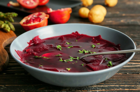 Plate of delicious beet soup on kitchen table