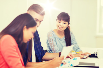 happy creative team or students working at office