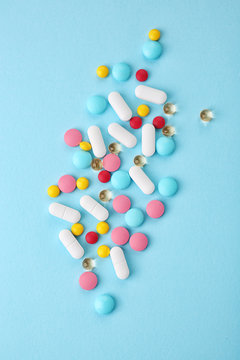Different pills on color background